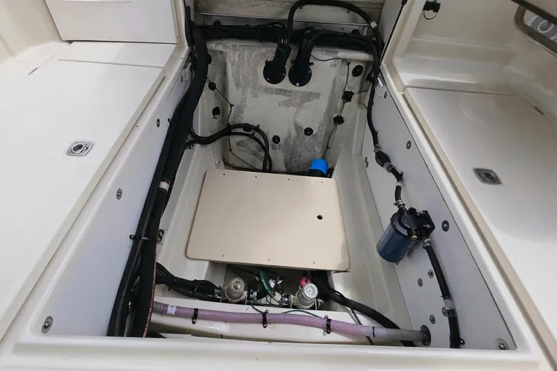 Slide: The Image of Engine compartment of a 2021 Ranger Tugs R-23 boat, showcasing wiring and components. - 6