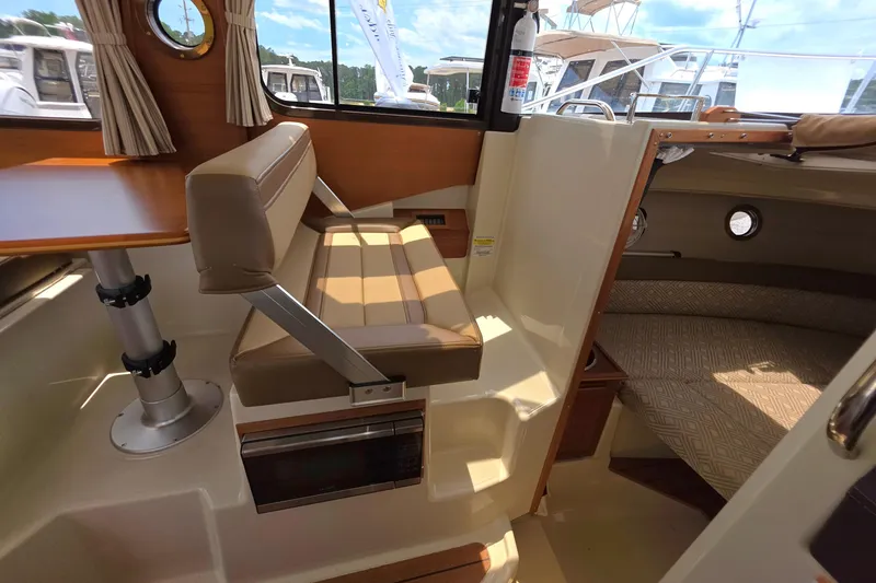 Slide: The Image of Interior of 2021 Ranger Tugs R-23 boat with seating and cabin area. - 7