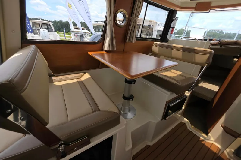 Slide: The Image of Interior of 2021 Ranger Tugs R-23 boat with seating and wooden table. - 8