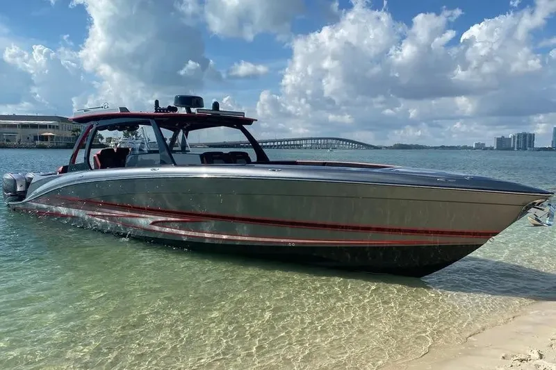 Slide: The Image of Sleek 2021 Concept 44' Open Deck boat on clear water with a scenic backdrop. - 2