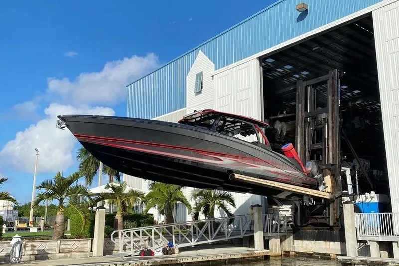 Slide: The Image of 2021 Concept 44' Open Deck boat being lifted from a marina storage facility. - 9