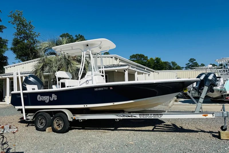 The Image of 2012 Tidewater 2200 Carolina Bay boat on trailer, parked outdoors. - 1
