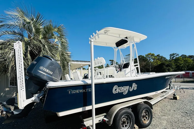 Slide: The Image of 2012 Tidewater 2200 Carolina Bay boat on trailer, Yamaha engine, palm trees in background. - 3