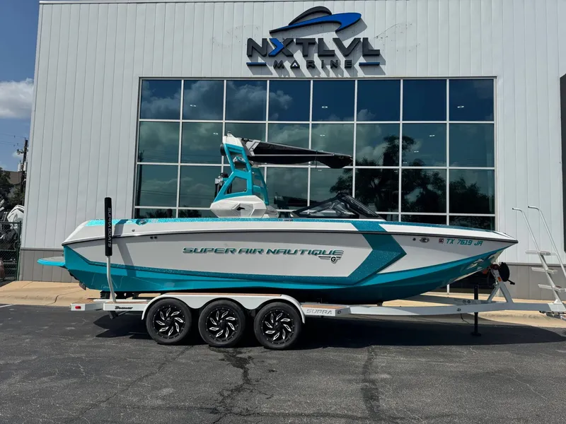 Slide: The Image of 2019 Nautique G25 boat in front of NXT LVL Marine building. - 2