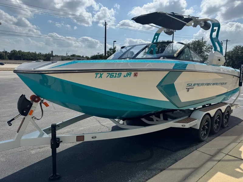 Slide: The Image of 2019 Nautique G25 boat on trailer, turquoise and white. - 6
