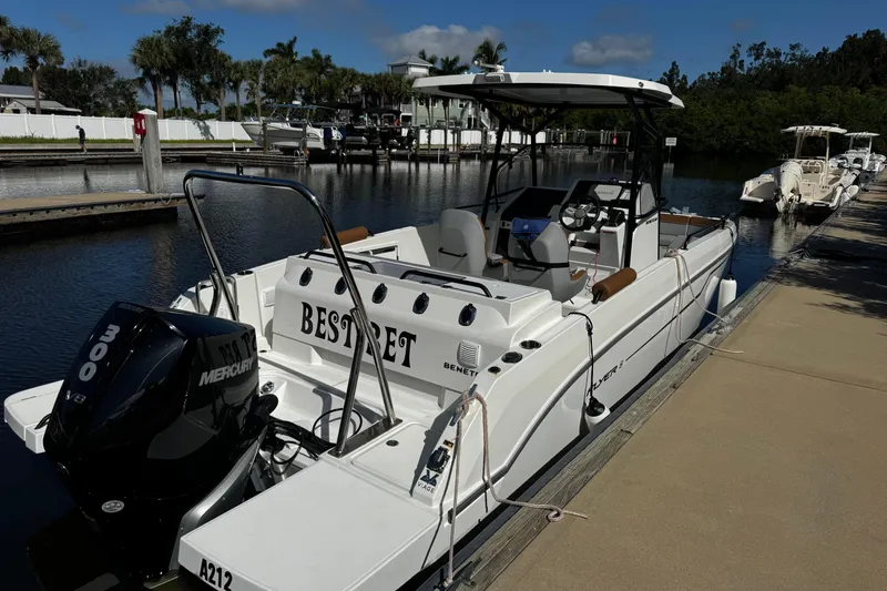 Slide: The Image of 2024 Beneteau Flyer 8 SPACEdeck moored at a marina, featuring a Mercury 300 engine. - 1