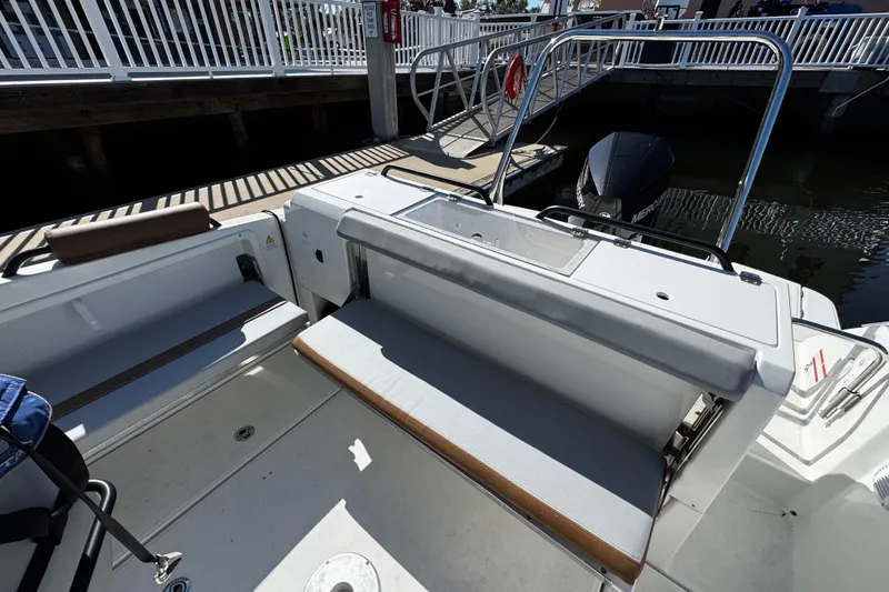 Slide: The Image of 2024 Beneteau Flyer 8 SPACEdeck boat interior with seating and railing at dock. - 10