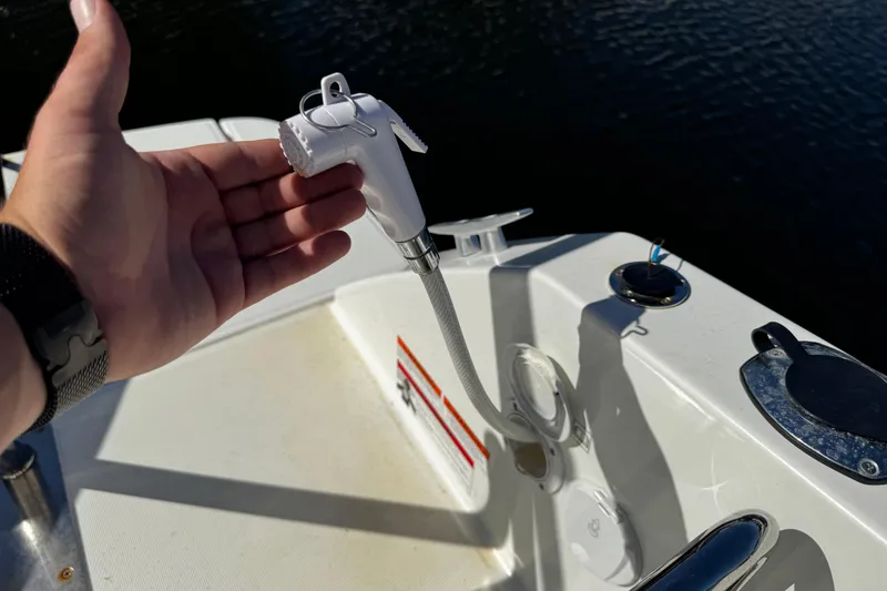 Slide: The Image of Hand holding a showerhead on a 2024 Beneteau Flyer 8 SPACEdeck boat. - 15