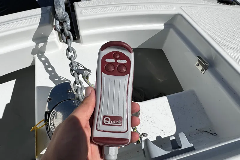Slide: The Image of Hand holding a Quick remote control on a 2024 Beneteau Flyer 8 SPACEdeck boat. - 19