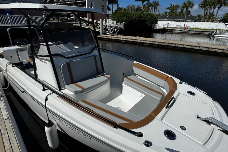 Slide: The Image of 2024 Beneteau Flyer 8 SPACEdeck boat docked by a marina, showcasing spacious seating. - 4