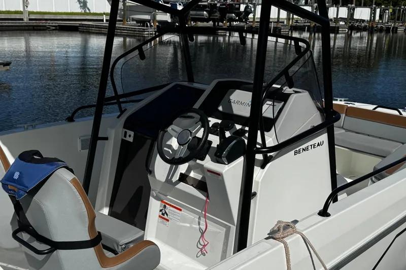 Slide: The Image of 2024 Beneteau Flyer 8 SPACEdeck cockpit with steering wheel and Garmin navigation system. - 5
