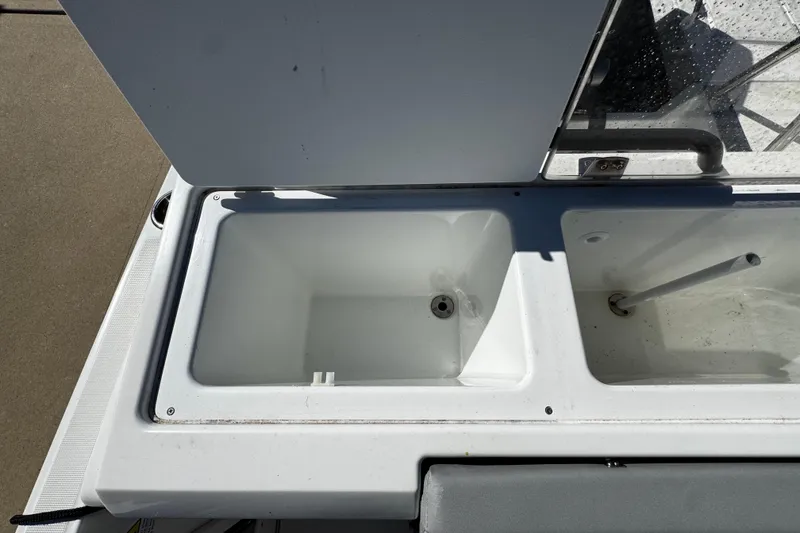 Slide: The Image of 2024 Beneteau Flyer 8 SPACEdeck storage compartments, open and empty, showcasing interior design. - 8