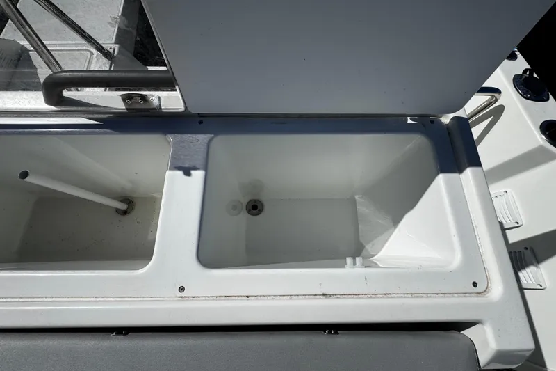 Slide: The Image of 2024 Beneteau Flyer 8 SPACEdeck storage compartments, open and empty, with visible drainage. - 9