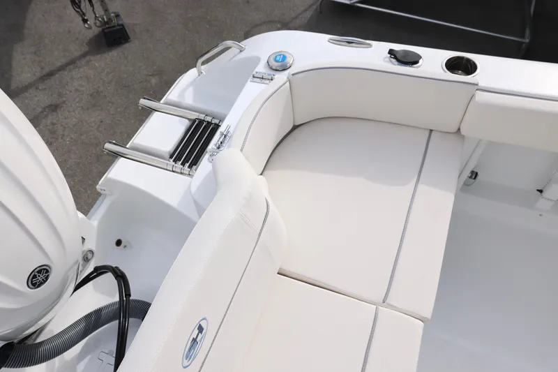 Slide: The Image of 2026 Sea Hunt Ultra 219 boat interior with white seating and stainless steel ladder. - 10