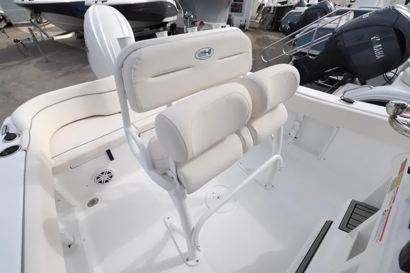 Slide: The Image of 2026 Sea Hunt Ultra 219 boat interior with white seating and Yamaha engine. - 11