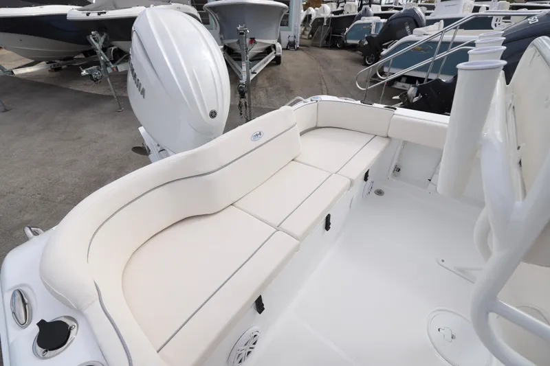 Slide: The Image of 2026 Sea Hunt Ultra 219 boat interior with white seating and Yamaha outboard motor. - 12