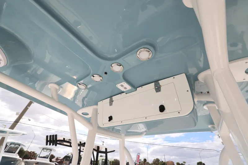 Slide: The Image of 2026 Sea Hunt Ultra 219 boat interior ceiling with lights and storage compartment. - 13