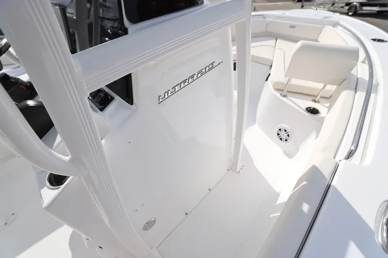 Slide: The Image of 2026 Sea Hunt Ultra 219 boat interior with white seating and console details. - 14