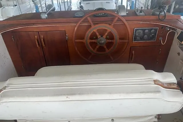 Slide: The Image of 1986 Pilgrim 40 boat helm with wooden wheel and control panel. - 15