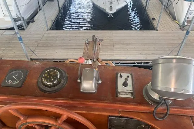 Slide: The Image of Pilgrim 40 boat helm with navigational instruments, docked at marina, 1986 model. - 16