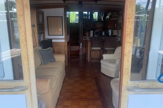 Slide: The Image of Interior of a 1986 Pilgrim 40 boat featuring cozy seating and wooden decor. - 18