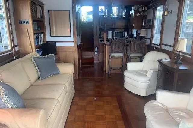 Slide: The Image of Interior of a 1986 Pilgrim 40 boat with cozy seating and wooden decor. - 20