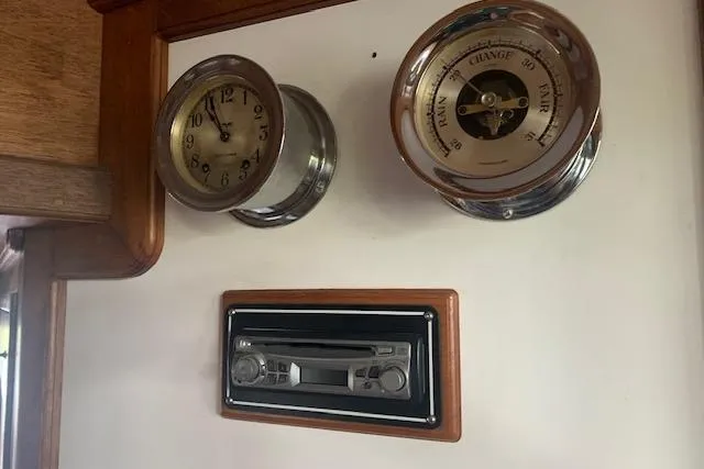 Slide: The Image of Vintage Pilgrim 40 yacht dashboard with clock, barometer, and cassette player, 1986 model. - 28