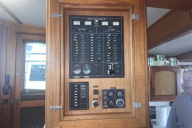Slide: The Image of Electrical control panel on a 1986 Pilgrim 40 boat, featuring various switches and gauges. - 29