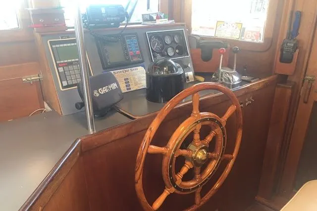 Slide: The Image of Pilgrim 40 boat helm with wooden wheel and navigation instruments, 1986 model. - 32