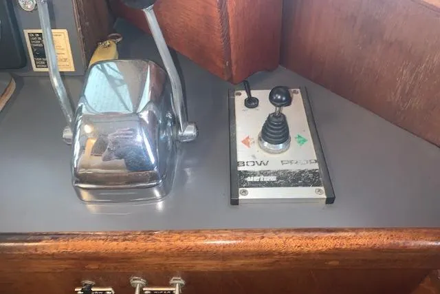 Slide: The Image of Control panel of a 1986 Pilgrim 40 boat with throttle and bow thruster joystick. - 34