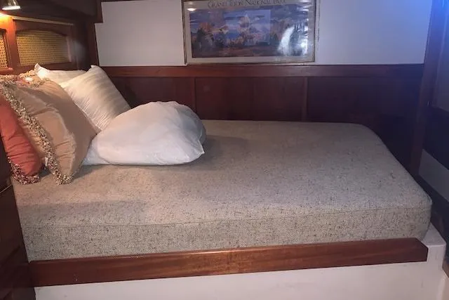 Slide: The Image of Cozy cabin bed in a 1986 Pilgrim 40 boat with decorative pillows. - 39