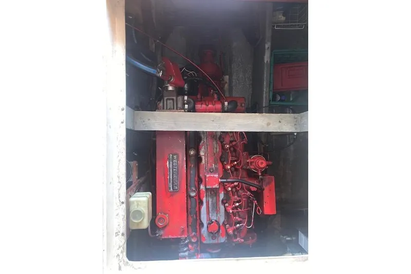 Slide: The Image of Red engine inside a 1986 Pilgrim 40 boat, showcasing mechanical components. - 41