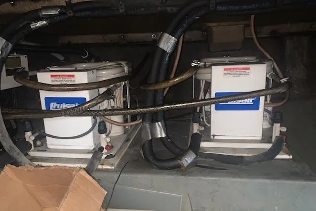 Slide: The Image of Cruisair units in a 1986 Pilgrim 40 boat engine room, surrounded by hoses and cables. - 45