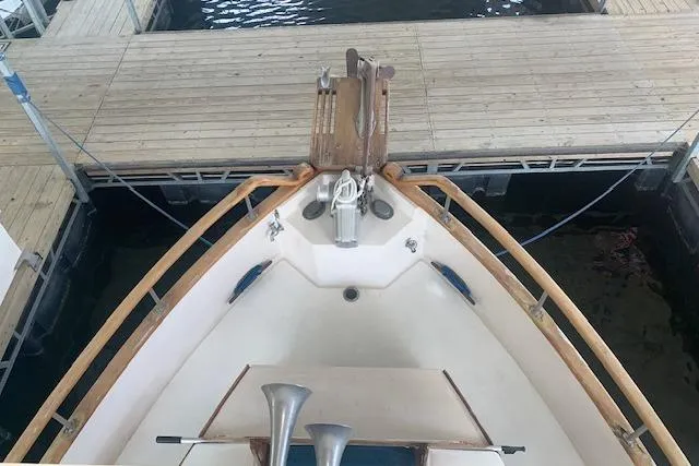 Slide: The Image of Bow view of 1986 Pilgrim 40 boat docked at a wooden pier. - 5