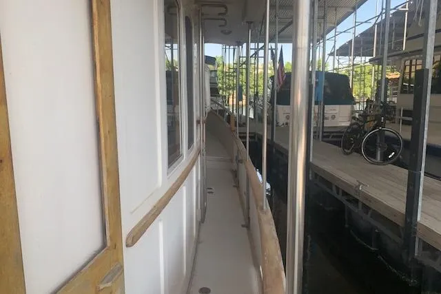 Slide: The Image of Narrow walkway on a 1986 Pilgrim 40 boat docked at a marina. - 7