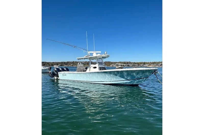The Image of 2015 Regulator 34 boat on calm water under clear blue sky. - 0