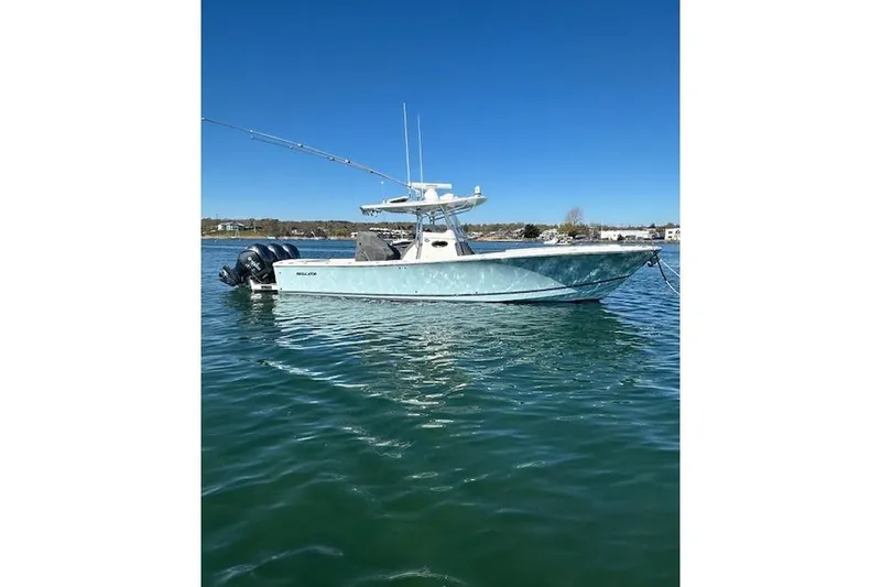 Slide: The Image of 2015 Regulator 34 boat on calm water under clear blue sky. - 1
