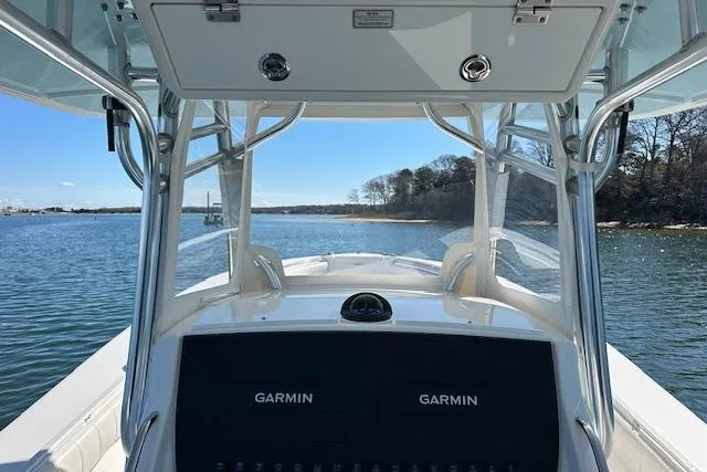 Slide: The Image of 2015 Regulator 34 boat with Garmin navigation, cruising on a calm waterway. - 18