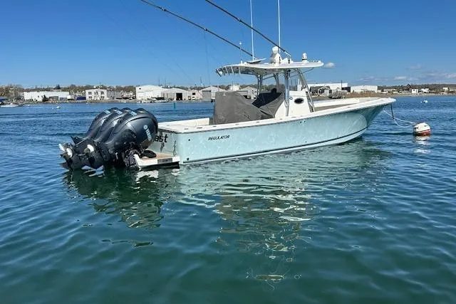 Slide: The Image of 2015 Regulator 34 boat with triple engines on calm water. - 2