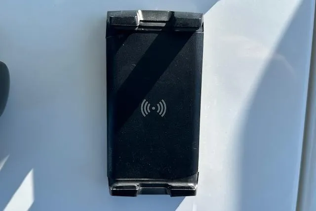 Slide: The Image of Black wireless charging pad on a 2015 Regulator 34 boat surface. - 20
