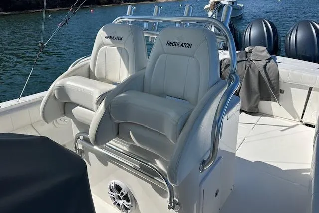 Slide: The Image of 2015 Regulator 34 boat with dual white captain's chairs on deck. - 22