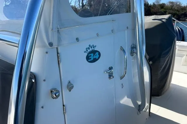 Slide: The Image of 2015 Regulator 34 boat cabin door with logo and chrome details. - 24