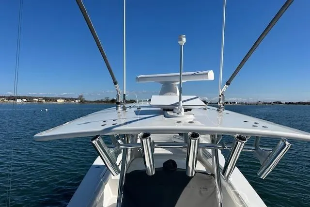 Slide: The Image of 2015 Regulator 34 boat with fishing rod holders on calm water. - 28