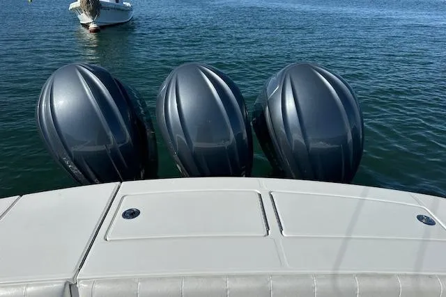 Slide: The Image of 2015 Regulator 34 boat with triple outboard engines on calm water. - 33