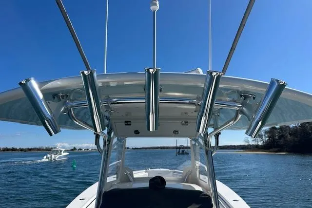 Slide: The Image of 2015 Regulator 34 boat with rod holders, cruising on a sunny day. - 34