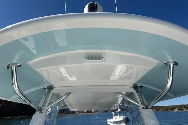 Slide: The Image of 2015 Regulator 34 boat's T-top view with stainless steel supports and clear blue sky. - 36