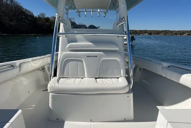 Slide: The Image of 2015 Regulator 34 boat with white seating, on calm water. - 37