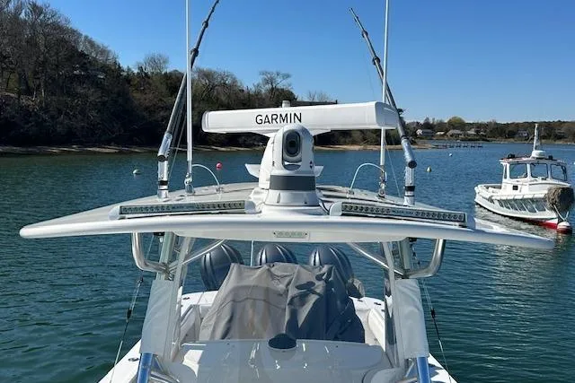 Slide: The Image of 2015 Regulator 34 boat with Garmin radar, docked in a serene water setting. - 39