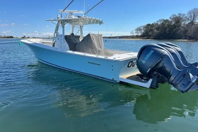 Slide: The Image of 2015 Regulator 34 boat with Yamaha engines on calm water. - 4