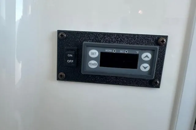 Slide: The Image of Control panel on a 2015 Regulator 34 boat, featuring on/off switch and digital display. - 42